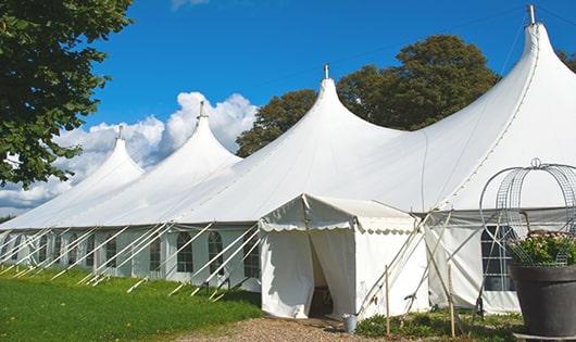 a row of blue portable restrooms waiting to be used at a special event in Franklin Lakes, NJ